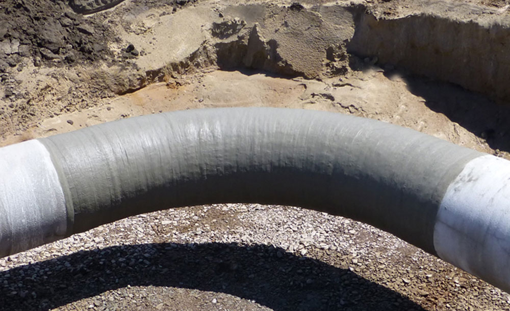 PrimaTape mechanical impact protection installed on pipeline elbow fitting